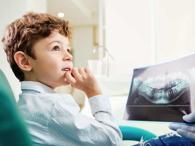 Child being examined for potential early orthodontic treatment