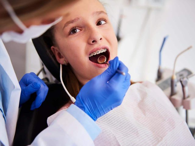 Orthodontist examining Child